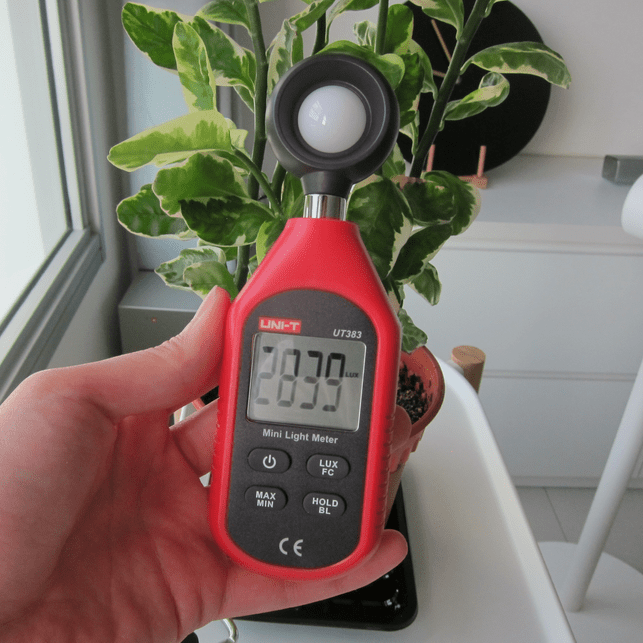 Checking home lighting with the UNI-T UT383 handheld lux meter, which shows a reading of 2839 Lux in a residential living area.