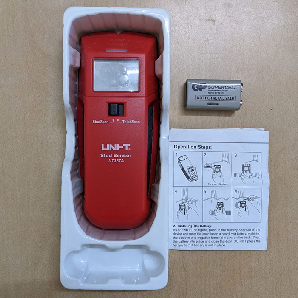 UNI-T UT387A entry-level stud finder inside the packaging with the included 9V battery.