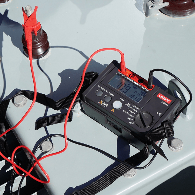 The UNI-T UT502A insulation tester connected to a large transformer, showing a 1.09 MΩ resistance reading on the digital display.