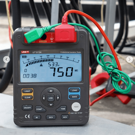 UNI-T UT513A insulation resistance tester testing electrical cable insulation with connected test leads, showing 750 megaohm resistance measurement for electrical safety verification