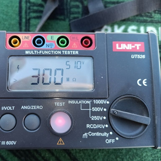 A UNI-T UT526 multifunction tester displaying a 300MΩ insulation resistance reading, showing its precision as a digital megohmmeter.