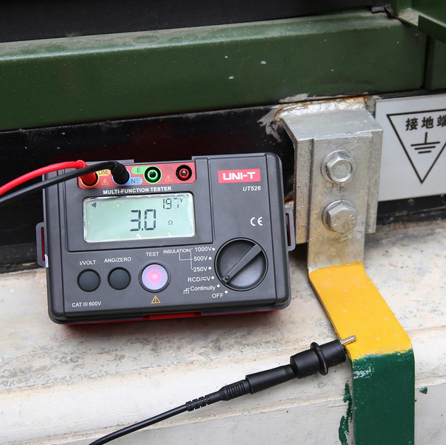 UNI-T UT526 performing an earth resistance test with leads connected, displaying a reading of 3.0 ohms on its high-resolution digital screen.