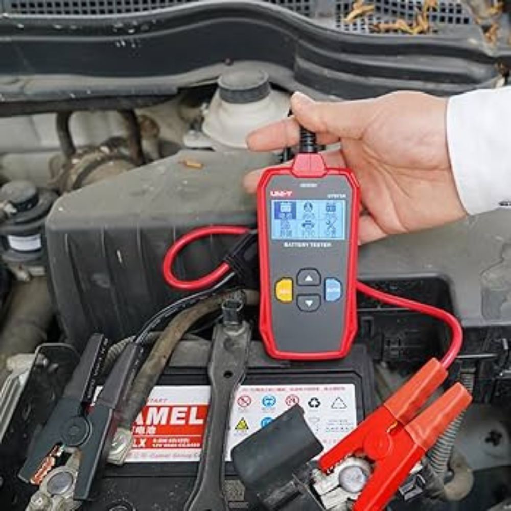 UNI-T UT673A battery tester connected to a car battery for testing
