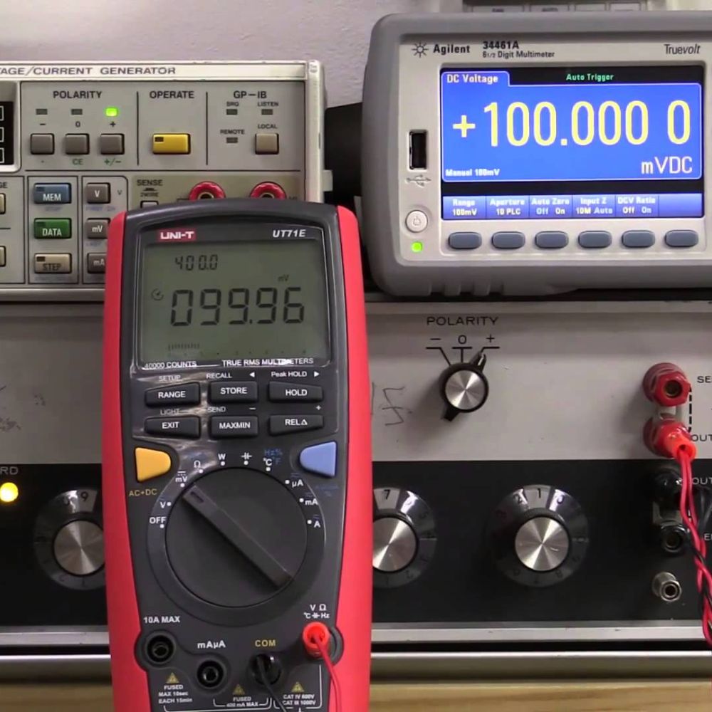 UNI-T UT71E True RMS Digital Multimeter connected to precision calibrator verifying measurement accuracy with ±0.025% DCV specification - Professional calibration testing for electronics production Sri Lanka.