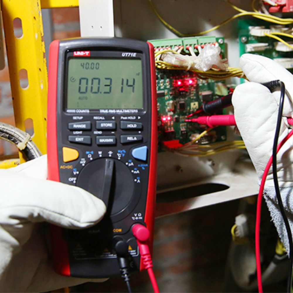 UNI-T UT71E Intelligent Data Logging Multimeter testing voltage and frequency on digital circuit board with test leads connected - Professional electronics troubleshooting and R&D testing Sri Lanka.