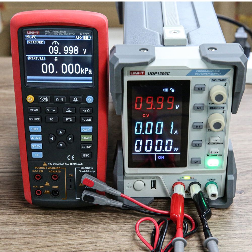 UNI-T UT725 multifunction calibrator performing DC voltage and 4-20 mA loop current test on programmable power supply for industrial process control validation.