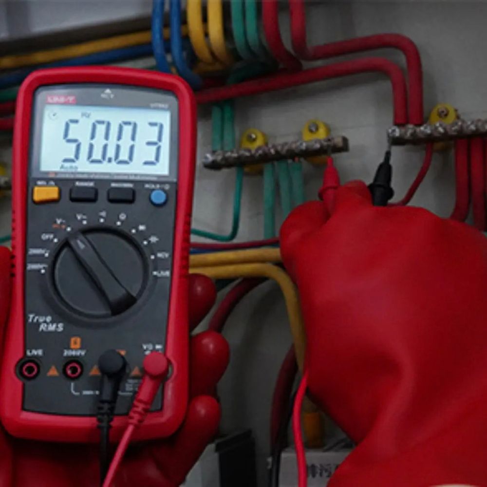 UNI-T UT892 2000V high voltage AC/DC digital multimeter testing a high voltage distribution board