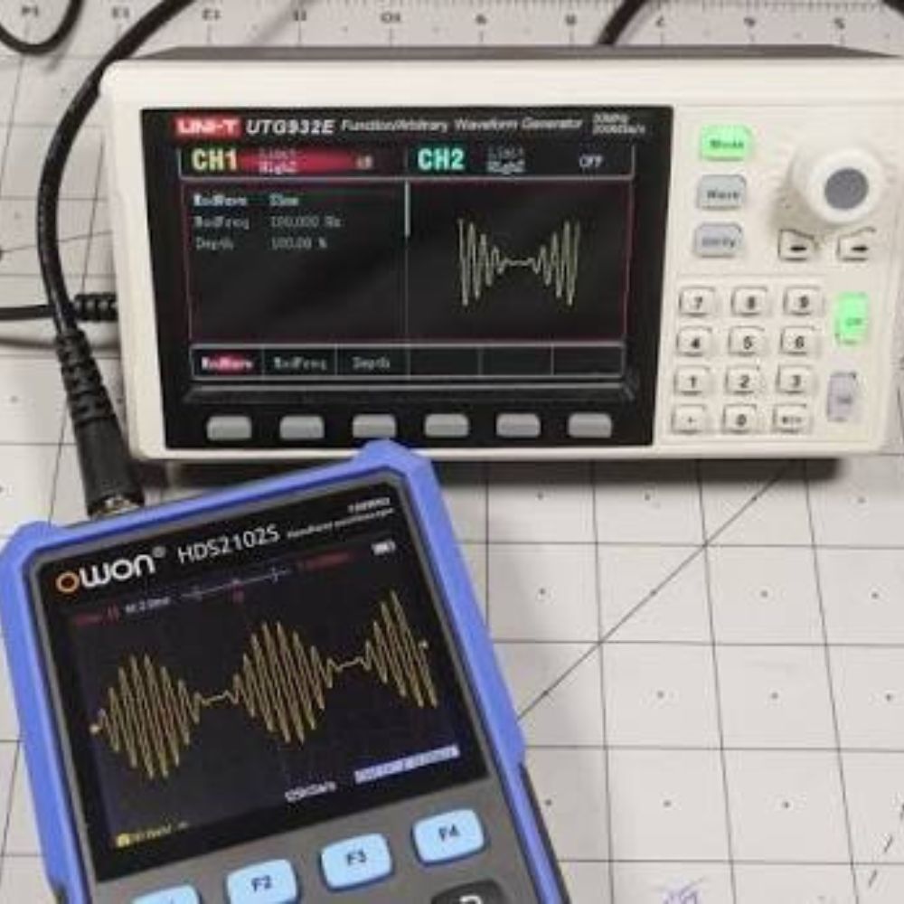 UNI-T UTG932E 30MHz dual-channel waveform generator working with an oscilloscope on an electronics test bench for signal and circuit analysis.