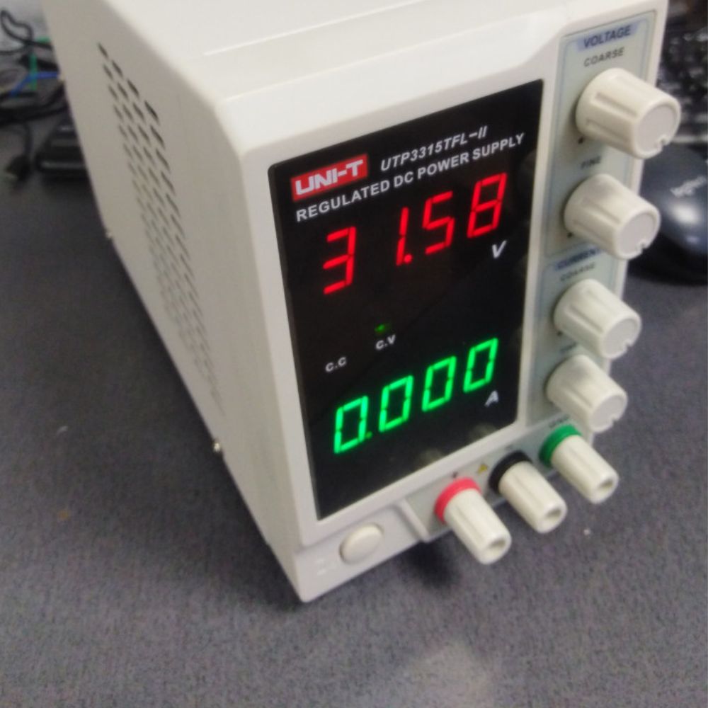 UNI-T UTP3315TFL-II single-channel high-current DC power supply ready for operation – linear bench PSU powering industrial electronics load for production testing.