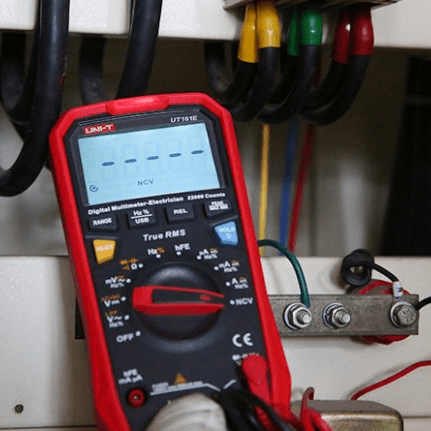 UNI-T UT161E high-voltage multimeter testing distribution panel board with safety-rated test probes, demonstrating CAT IV 600V capability for power system maintenance.