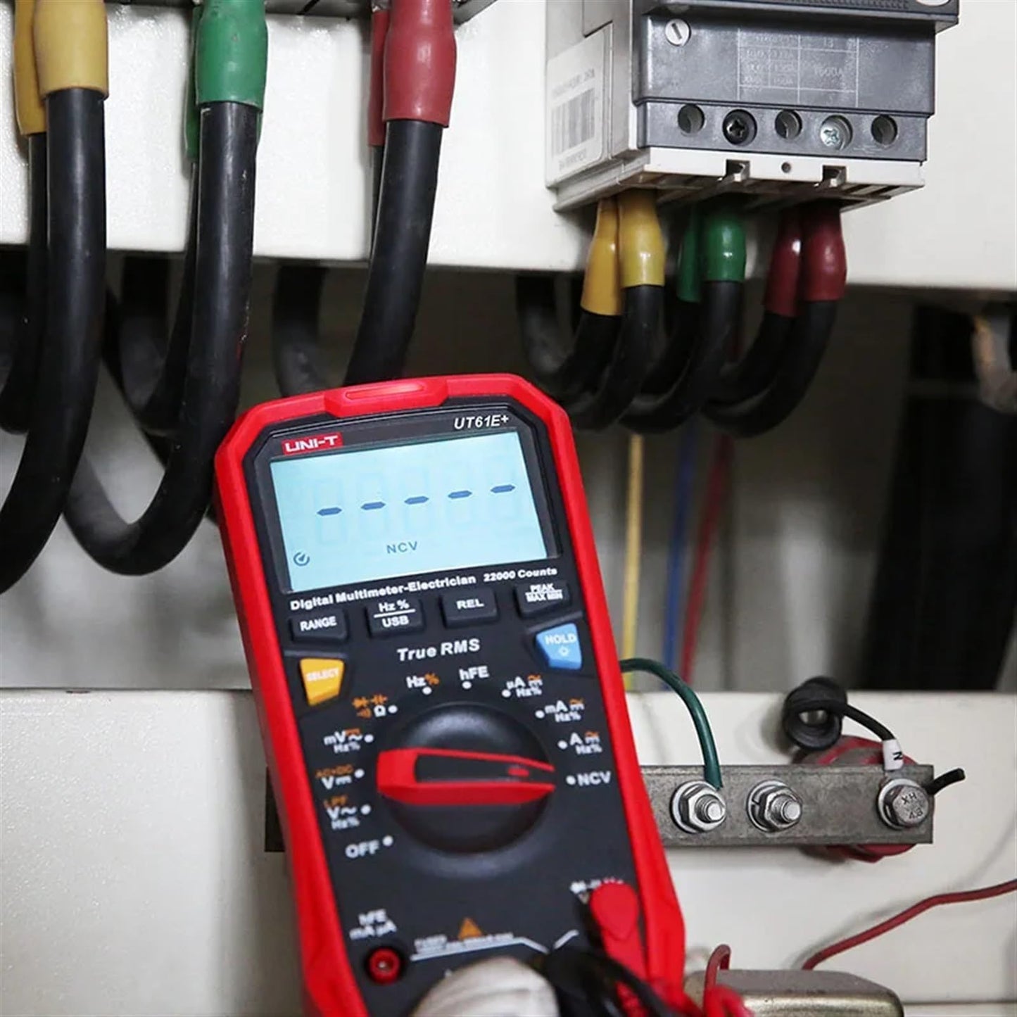 UNI-T UT61E+ in Non-Contact Voltage (NCV) detection mode near a VFD control panel, demonstrating safety features for industrial electricians and HVAC automation diagnostics.
