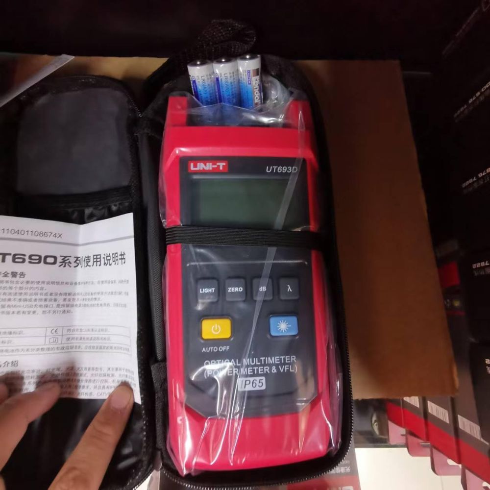 UNI-T UT693D optical diagnostic tool securely packed in its portable carrying case alongside AA batteries and the official factory calibration certificate.